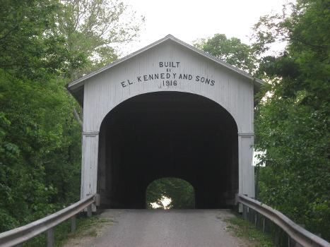 Eastern portal of the Norris Ford Covered Bridge:The bridge carries County Road 150N over the Flatrock River northeast of Rushville in Rushville Township, Rush County, Indiana, United States. Built in 1916, it is listed on the National Register of Historic Places.