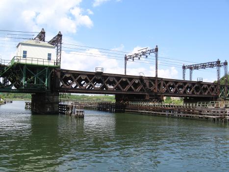 Railroad bridge over the Norwalk River as seen from the south on the South Norwalk side : This is the only swing bridge on the New Haven Line. When a ship needs to pass the bridge, the middle part swings (or turns) so that it is parallel with the river. The bridge is on the National Register of Historic Places. At this spot in 1853, a previous swing bridge was not ready for a train, which plunged into the river, killing dozens in one of the worst railroad accidents up to that time.