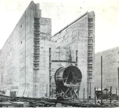 The Panama Canal locks under construction, in 1910. The partly-constructed middle wall is shown here; the large pipe near the bottom is the culvert used to carry water into the locks. The man standing below and right of it illustrates the scale From The Panama Canal , An address to the National Geographic Society, by Colonel Goethals, February 10, 1911
