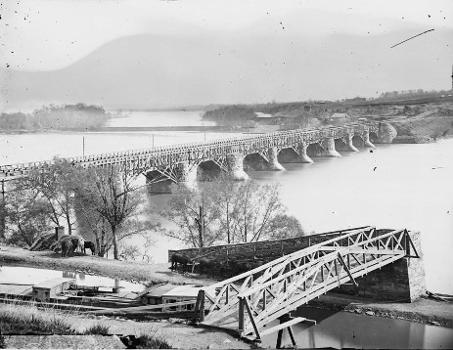 The Potomac Aqueduct Bridge, Washington, D.C.,:with Virginia in background and Georgetown and the Cheasapeake &amp; Ohio Canal in the foreground. At this time, the bridge carried only a canal.