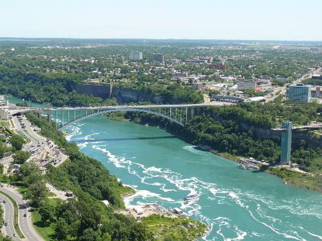 Rainbow Bridge:The Rainbow Bridge, seen from the Skylon Tower, at Niagara Falls is an international steel arch bridge across the Niagara River gorge. It connects the cities of Niagara Falls, New York, United States (to the east), and Niagara Falls, Ontario, Canada (west).