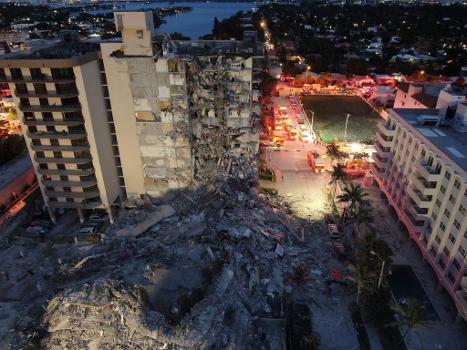 Aftermath of the Surfside condominium building collapse : The collapse occurred on June 24, 2021. It shows the rubble that resulted from the collapse, and also clearly shows the standing portion of the building.