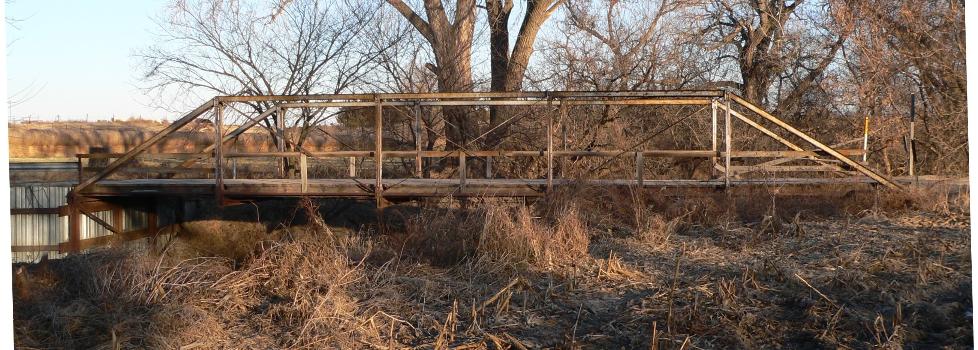 Sweetwater Mill Bridge in Buffalo County, Nebraska, seen from the west. : The pin-jointed Pratt pony truss bridge carries Sweetwater Road across Mud Creek. It was built in 1909 by the Standard Bridge Company, and is listed in the National Register of Historic Places.