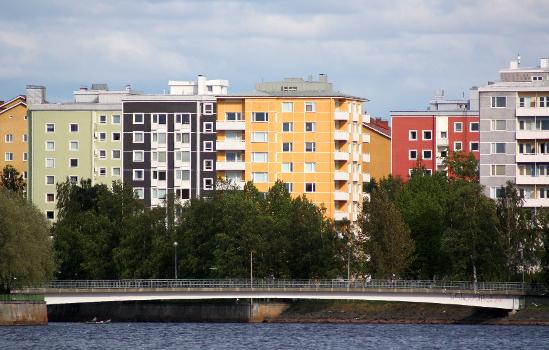Apartment buildings in Toivoniemi island in Oulu with a pedestrian and bicycle bridge in the foreground