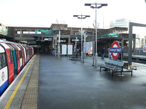 Looking south from the northern end of the northbound platforms at Wembley Park tube station : The train on the left is a Jubillee Line 1996 tube stock EMU.