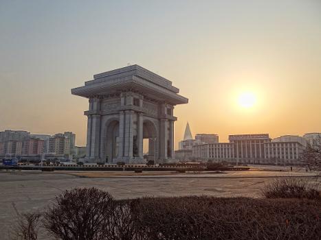 The Arch of Triumph in Pyongyang, photographed from the north-east in at sunset:The pyramidal building in the background is the Ryugyong Hotel, the tallest building in the DPRK.