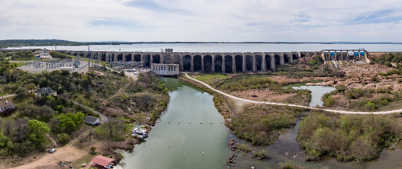 A view of Buchanan Dam, located west of Burnet, Texas, showing the arched structure, floodgates, the power house and electrical yard.