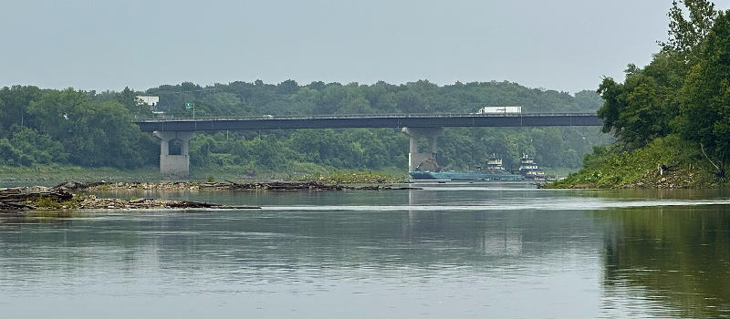 A river barge passes beneath the west side of the second Chouteau Bridge, going toward Riverfront Park in 2023.