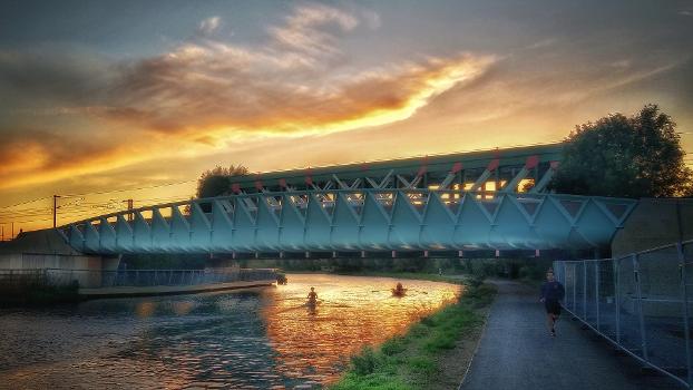 The Abbey–Chesterton cycle and footbridge on the Chisholm Trail in Cambridge, UK viewed from the north at sunset.