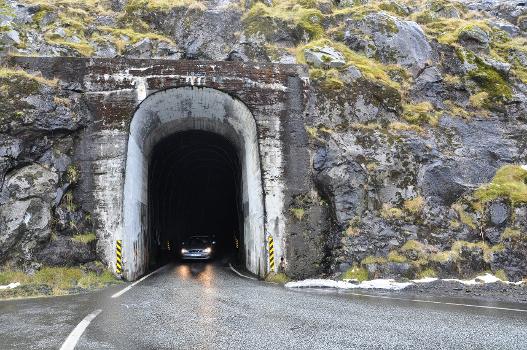 Hvannasundstunnilin (Hvannasund Tunnel):Entrance of the Hvannasundstunnilin (Hvannasund Tunnel) close to Norðdepil on the island Borðoy, Faroe Islands. This tunnel was built in 1967. It is 2120 m long and connects Norðdepil with Árnafjørður. It has only a single lane and no lights. There's one priority direction, with a series of passing places on the other side. This tunnel is one in a series of two that connects Klaksvík with the eastern side of Borðoy and with the island Viðoy. The other is the Árnafjarðartunnilin (Árnafjørður Tunnel) that connects Klaksvík and Árnafjørður (1680 m long, built in 1965, also single lane, no lights).