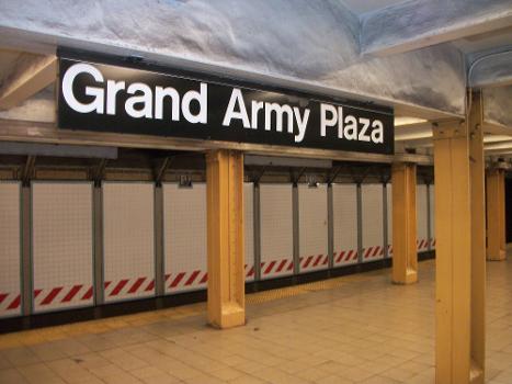 A large overhead Helvetica sign over the platform at Grand Army Plaza (IRT Eastern Parkway Line) station in Brooklyn, New York City