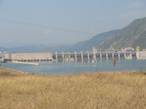 Iron Gate I Dam:Downstream side of the Đerdap I (Iron Gate I) hydroelectric power plant on Danube, seen from Serbian coast; in the middle a pylon of the 400 kV overhead power line crossing (connecting Romanian and Serbian substations).
