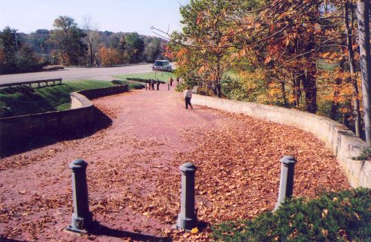 Tourists and autumn leaves linger on the Fox Run S-Bridge which has a restored red brick surface