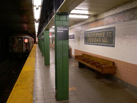 A view of the northbound platform of the IRT Broadway-Seventh Avenue Line's Christopher Street-Sheridan Square station. An R62A 1 train departs.