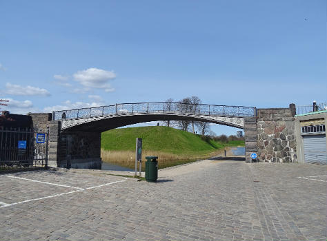 The green cycle route Langelinieruten passing under Gefionbroen in Indre By in Copenhagen. In the background the citadel Kastellet can be seen.