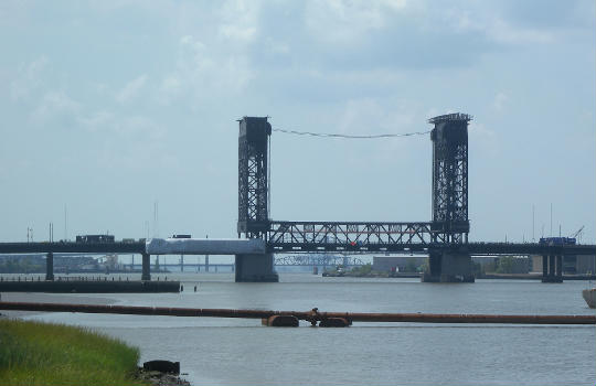 Looking south from Duncan Avenue along the Hackensack River at the distant Lincoln Highway Lift Bridge on a sunny midday