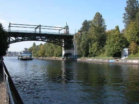 Montlake Bridge from the east : The approaching boat is M/V Kirkland which, like the bridge and the Lake Washington Ship Canal whose Montlake Cut is spanned by the bridge, is on the National Register of Historic Places.