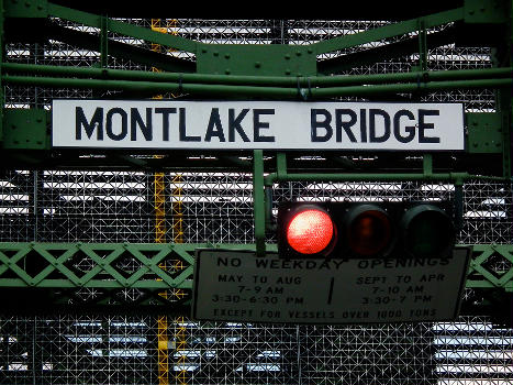 Sign and red light on the north end of the Montlake Bridge during an opening of the bridge, Opening Day of Boating Season, Seattle, Washington, USA.