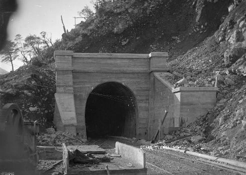 View of the mouth of the Otira railway tunnel at Arthur's Pass in 1910 during construction.