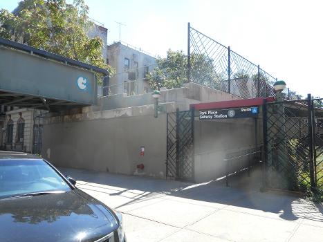 The Prospect Place entrance to the Park Place (BMT Franklin Avenue Line) subway station:The right-of-way for some southbound tracks can be seen between the bridge and the entrance.