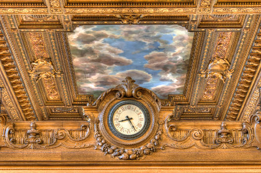 The Clock of the Reading Room at the top of the Delivery Desk wall.