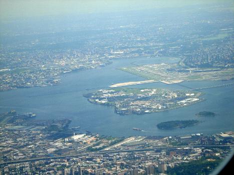 A view of Rikers Island in New York, United States, looking south from the air over The Bronx. : LaGuardia Airport can be seen in the background. Flushing Bay, Shea Stadium and Citi Field can be seen slightly behind LaGuardia. Vernon C. Bain Correctional Center can be seen in the lower left as the blue and white docked prison barge. The Hunts Point Wastewater Treatment Plant is located to the right of the Bain Correctional Center.