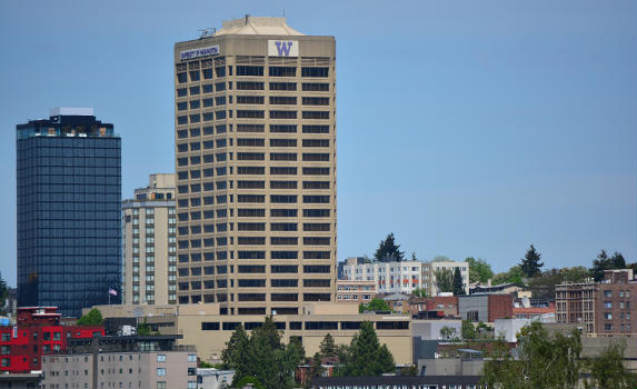 UW Tower, University of Washington, Seattle, Washington, seen here from the Interstate 5 Ship Canal Bridge : At left, The M, a new residential highrise at NE 47th and Brooklyn NE. Between them, the hotel that has been known variously over the years as the Meany, University Tower, Deca, and the Graduate.