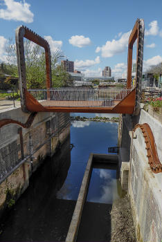 The Cody Dock Rolling Bridge designed by Thomas Randall-Page : The square cog design, rolling on catenary curve tracks - together with a balanced centre of gravity - enables the bridge to be rolled between higher and lower positions with minimum effort.