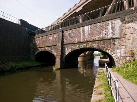 Stewart Aqueduct:The Stewart Aqueduct, carrying the BCN Old Main Line Canal over the BCN New Main Line Canal in Smethwick, West Midlands (formerly in Staffordshire), England. Alongside and above the New Main Line Canal is the Stour Valley railway section of the West Coast Main Line, all three being bridged by the M5 motorway.