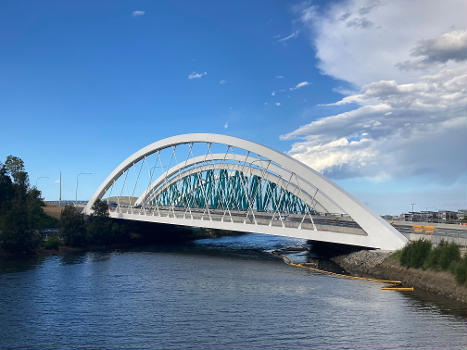 The Twin Arch Bridges as part of the Sydney Gateway project, viewed from the shared path bridge across Alexandra Canal. The eastbound bridge has been completed and open to traffic. The westbound bridge at the back is still under construction.