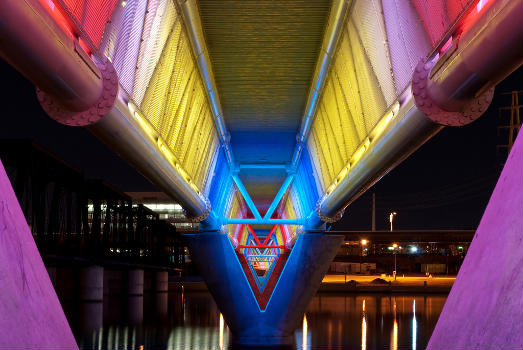 Illuminated bridge of the Light Rail running over Tempe Town Lake.