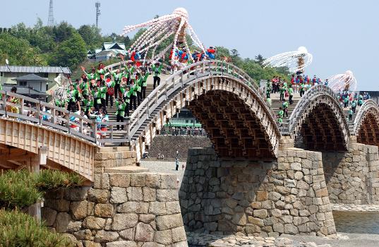Kintai Bridge:Thousands of visitors congregated at the 28th annual Kintai Bridge Festival, to soak up the sun and Japanese culture while they watched the Daimyo and Young Warriors Procession Parade, April 29. While a group of local Japanese volunteers, dressed as Samurais, shot at targets enacting olden times, the parade moved across the 210-meter long Kintai bridge.