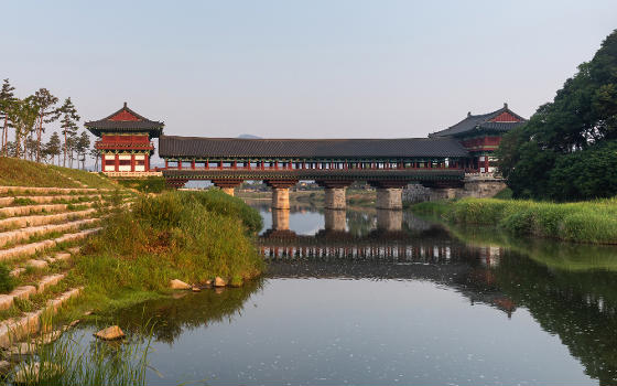 Water reflection of Woljeonggyo Bridge and stone steps with grass on the bank at in the morning, in , .