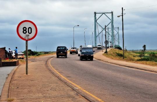 Speed limit sign, 80 km/h, in Xai-Xai, Mozambique. Bridge over the Limpopo river in the background.