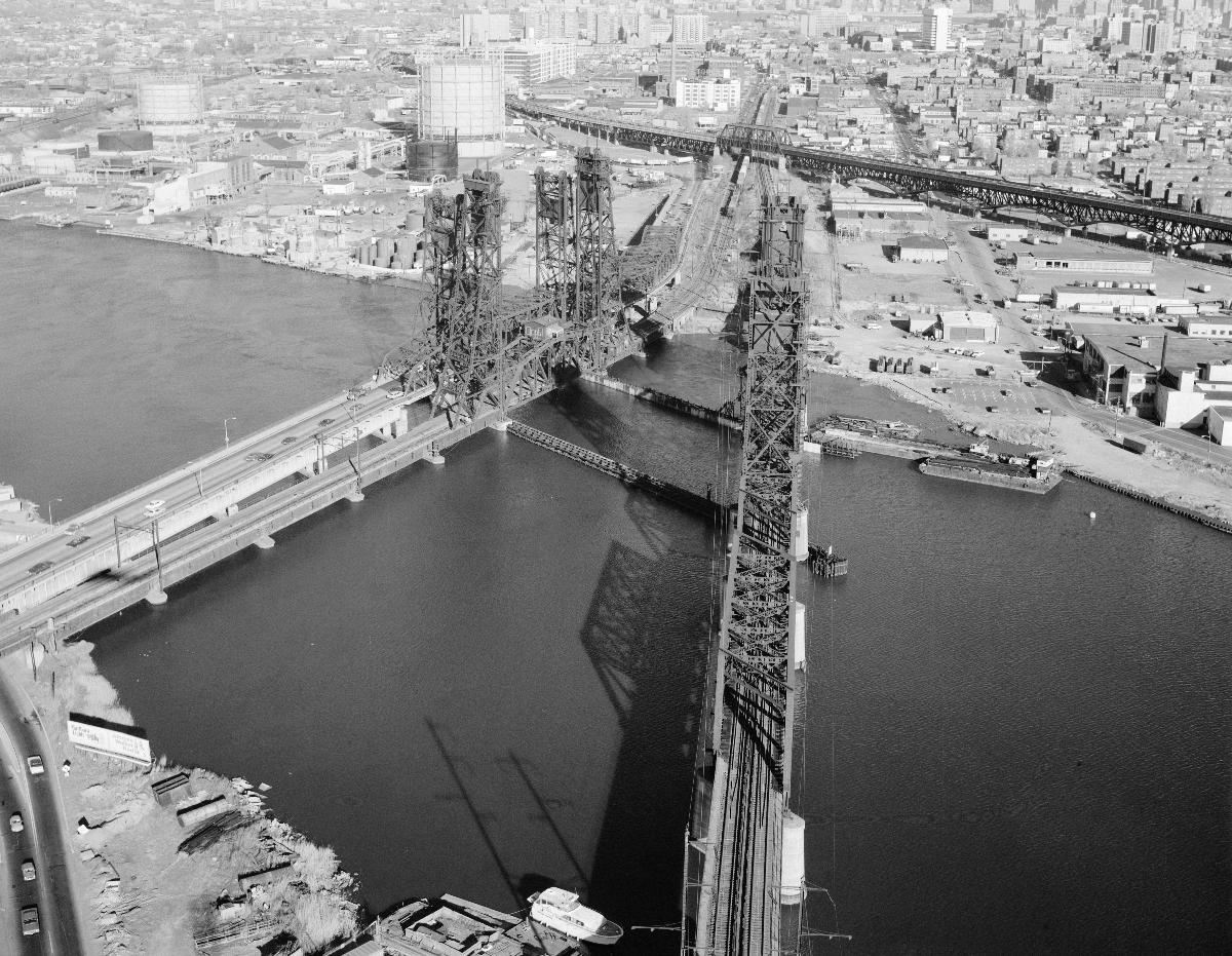 Media File No. 290920 Aerial "barrel" shot of the PATH transit system bridge, looking southeast towards Jersey City. To the left are the Newark turnpike and the Conrail bridge. The Pulaski Skyway is in the background to the right
