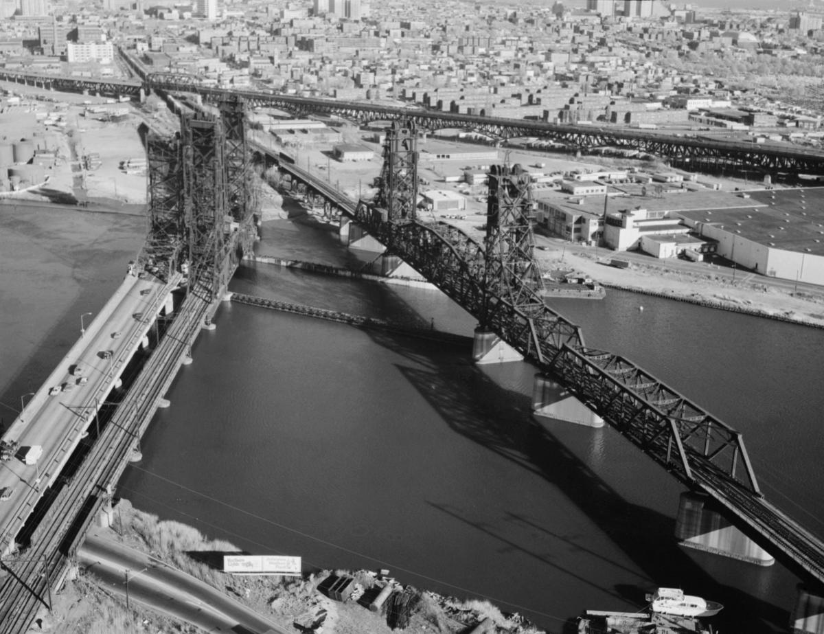 Media File No. 290921 Aerial view of the PATH transit system bridge looking southeast. To the left are the Newark turnpike and the Conrail bridge. The Pulaski skyway is in the background
