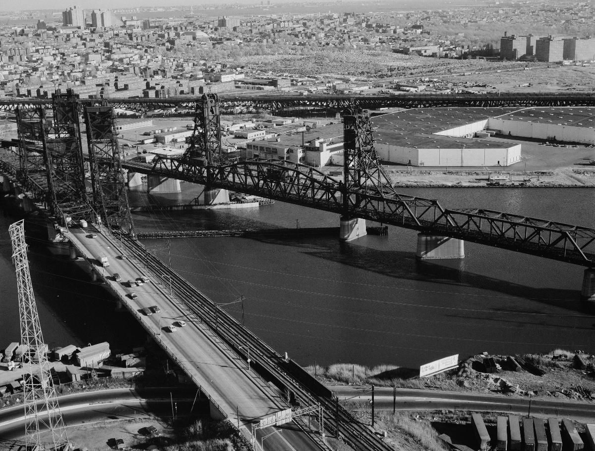 Media File No. 290922 Aerial view of the PATH transit system bridge looking southeast. To the left are the Newark turnpike and the Conrail bridge. The Pulaski Skyway is in the background