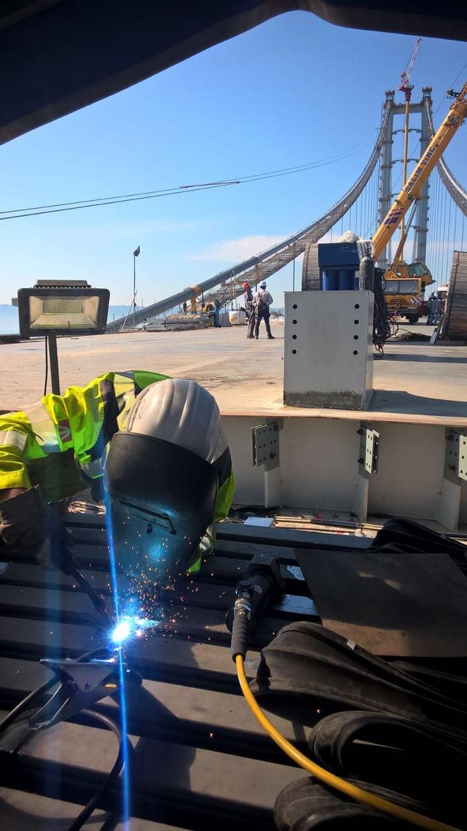 Media File No. 265648 The connection welding of the two expansion joints on site requires maximum concentration and a very professional mode of operation. The Southern, 252 m high pylon of the Izmit Bay Bridge is visible in the background