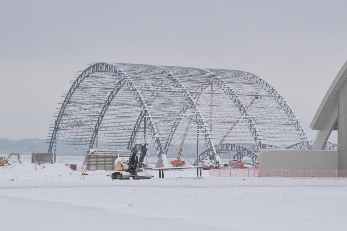 Media File No. 241333 DAYTON, Ohio – Iron workers assemble steel archways during the first snowfall of the season. The 224,000 square foot building, which is scheduled to open to the public in 2016, is being privately financed by the Air Force Museum Foundation, a non-profit organization chartered to assist in the development and expansion of the museum's facilities