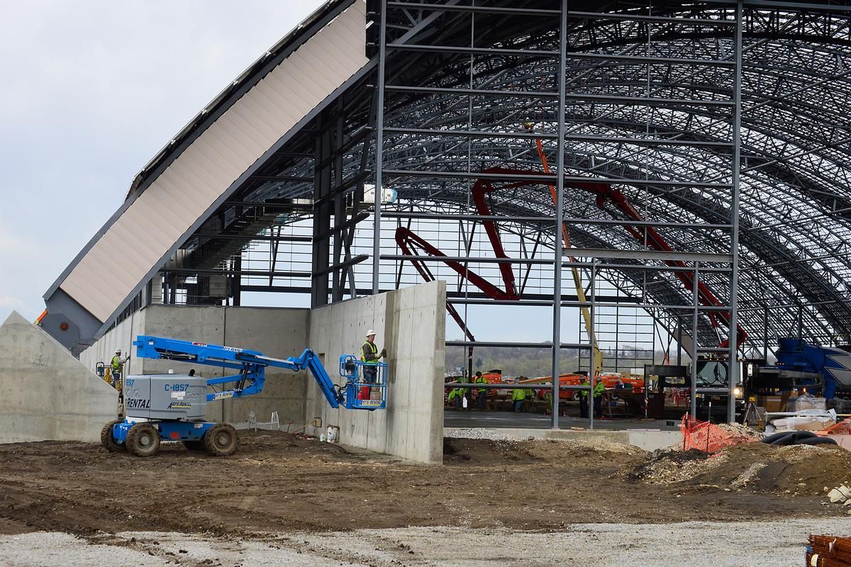 Media File No. 241318 DAYTON, Ohio – Construction crews install concrete at the east end of the fourth building construction site on April 14, 2015, in Dayton, Ohio. The 224,000 square foot building, which is scheduled to open to the public in 2016, is being privately financed by the Air Force Museum Foundation, a non-profit organization chartered to assist in the development and expansion of the museum's facilities