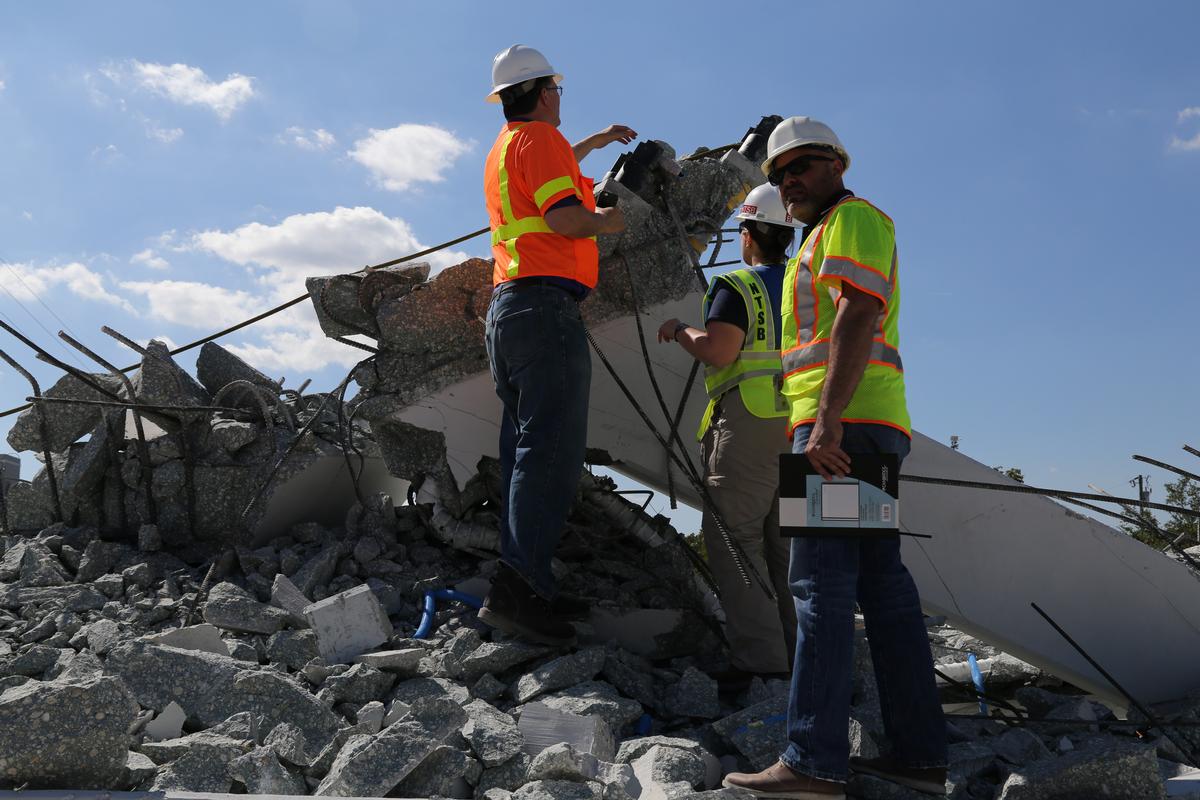 Media File No. 293124 Federal investigators, including NTSB’s Adrienne Lamm, an NTSB materials engineer in the Materials Laboratory Division of the Office of Research and Engineering, examine the debris from Thursday’s collapse of a bridge on FIU’s campus. The NTSB’s Go Team began arriving on scene at 10 p.m. Thursday and has been working around the clock to gather information and evidence in its investigation of the accident.