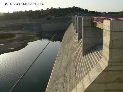 Media File No. 71971 Pedrogao dam, Moura (Portugal, 2006). Completed in March 2006, the Pedrogao dam is a RCC gravity dam (H = 43 m, L = 473 m) with an uncontrolled overflow stepped spillway (h = 0.6 m, 1V:0.75H). The dam is equipped also witha fish lock/lift. The reservoir is located immediately downstream of the Alqueva dam which is multipurpose reservoir for irrigation (326 km of open channels, 9 main pump stations) and hydropower (2 * 130 MW pump-turbines). Photograpsh taken on 4 Sept. 2006