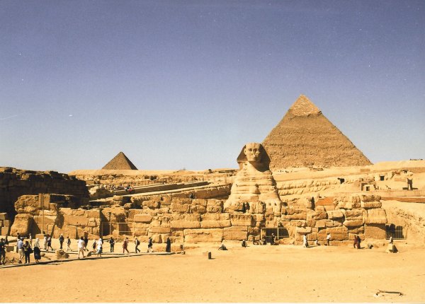 Sphinx in front of the Pyramid of Chefren. Pyramid of Mycerinus to the left 
