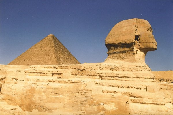Side view of the Sphinx with the Pyramid of Cheops in the back 