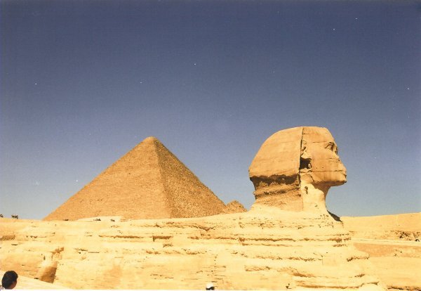Side view of the Sphinx with the Pyramid of Cheops in the back 