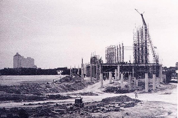Rice Stadium Construction progress, early 1950. West stands started. Recently opened Shamrock hotel in distance