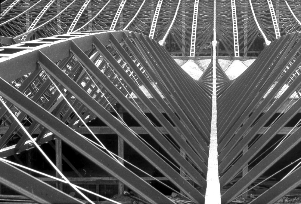 Media File No. 55231 This view of the Supersam supermarket, under construction in Warsaw, Poland, shows the funicular roof system of tensile cables and compressive arches, with connecting members at various angles