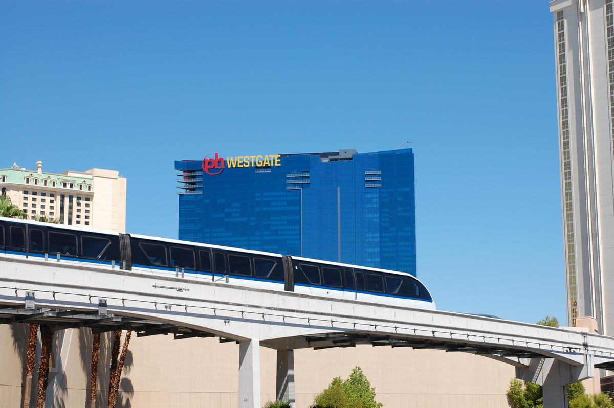 A train on Las Vegas Monorail System passes by, with Planet Hollywood Towers by Westgate in the background 
