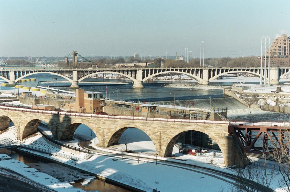 Media File No. 122840 Three structures in one photo: Stone Arch Bridge in the foreground; The Upper Saint Anthony Falls Lock and Dam in the middle; And the Third Avenue Bridge in the background