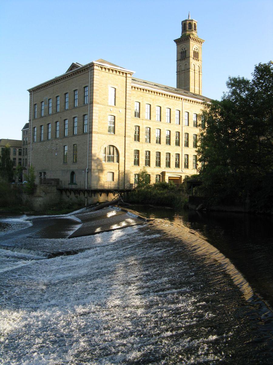 North West corner of New Mill, Saltaire taken over a weir on the River Aire 